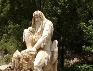 human sitting on stone statue thumbnail