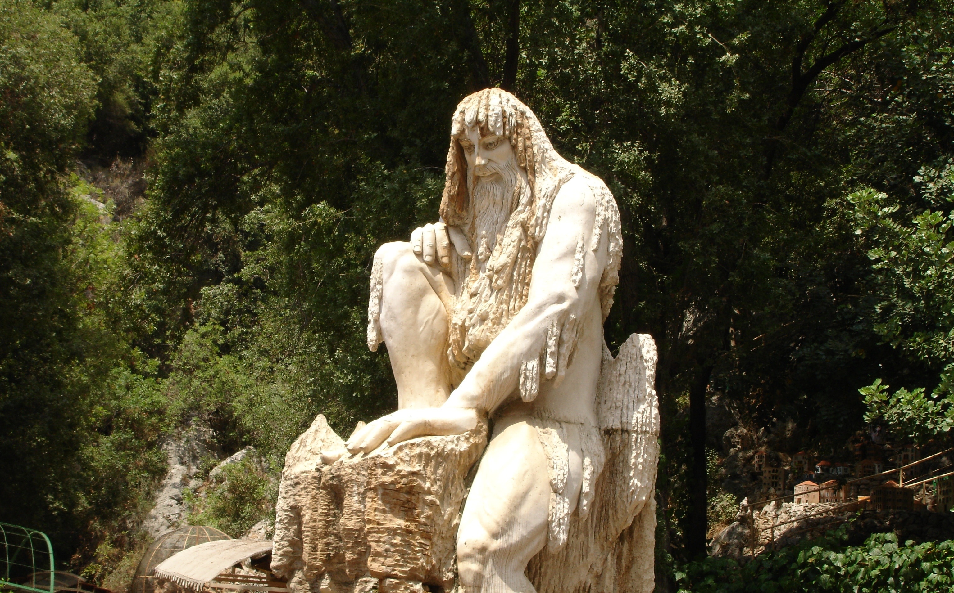 human sitting on stone statue