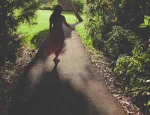 woman in long dress along concrete pathway during daytime thumbnail
