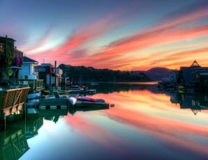 houses beside  the body of water on sunset thumbnail
