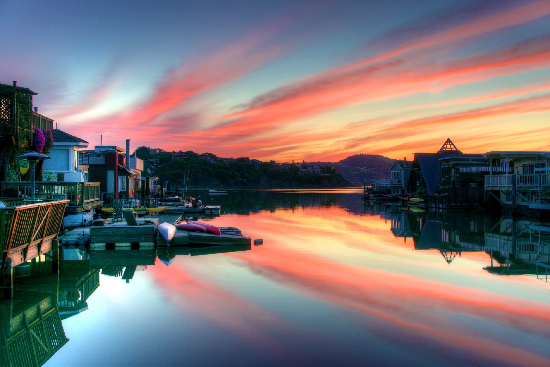 houses beside  the body of water on sunset
