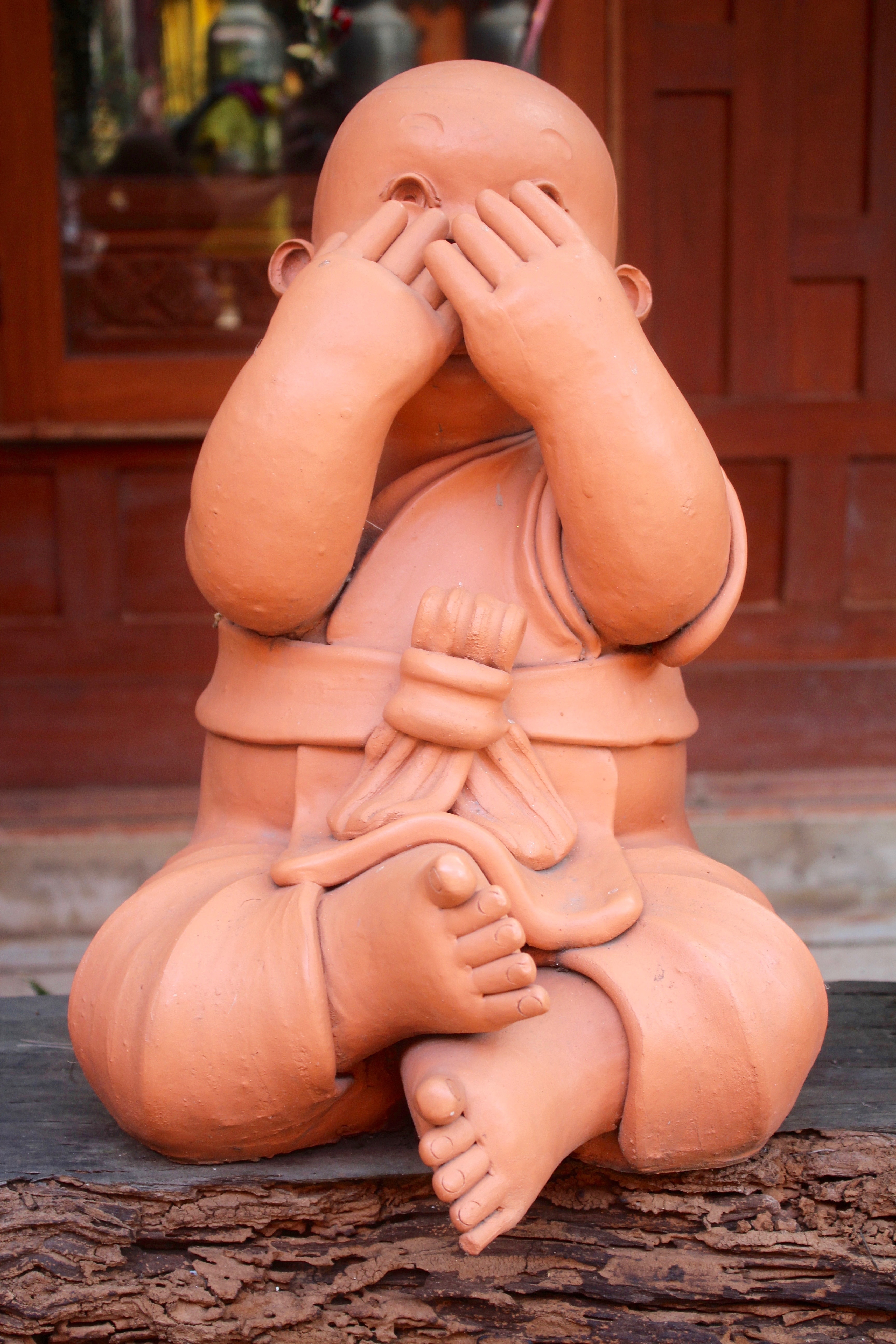 brown ceramic baby figure