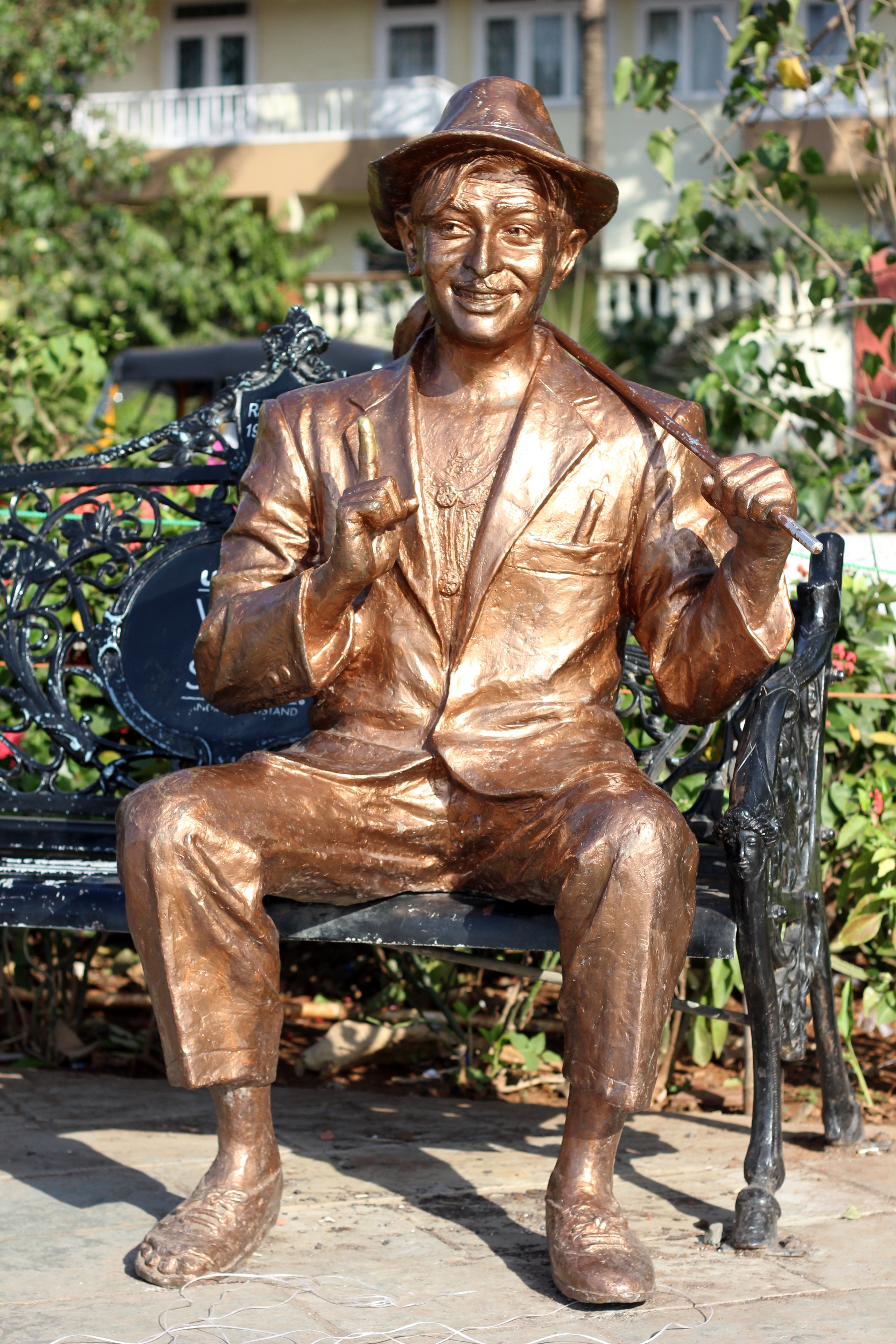 bronze boy sitting on bench statue