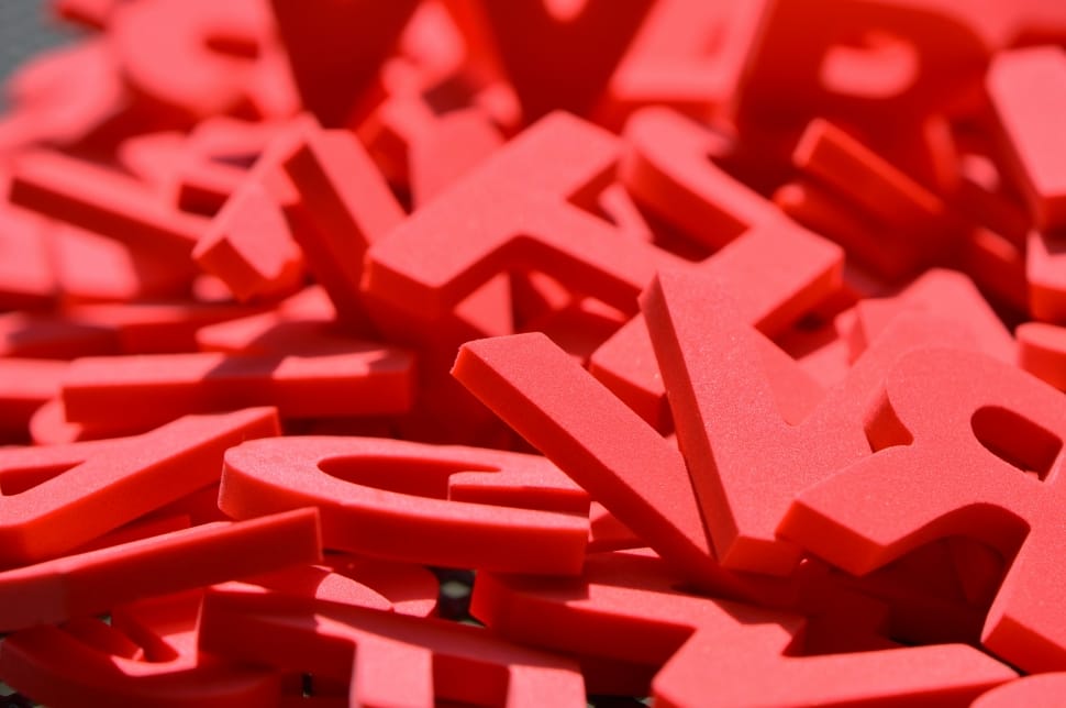 red Letters plastic in close up photography preview