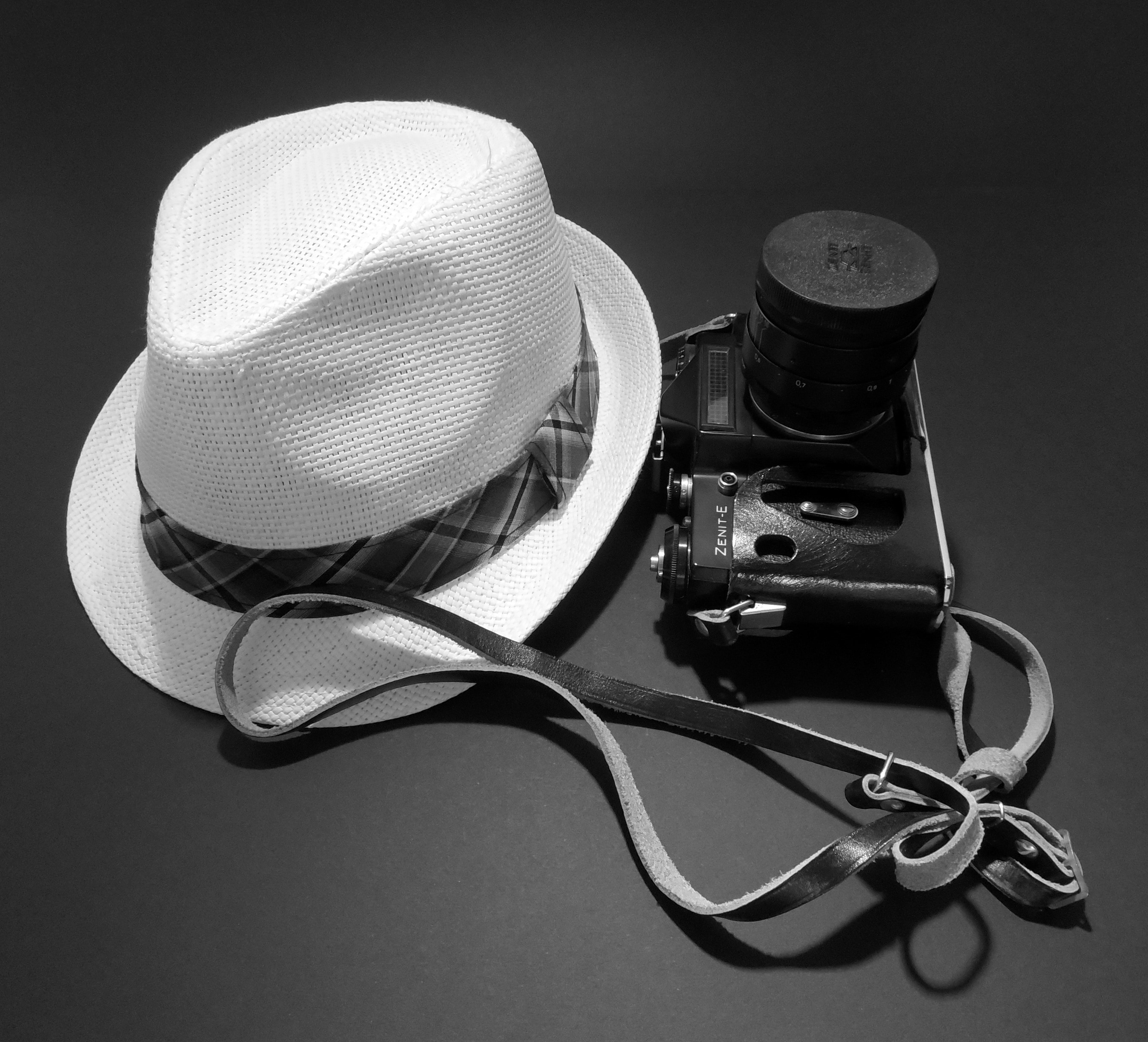 white fedora hat and black dslr camera