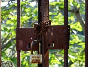 gray metal padlock with brown chain thumbnail