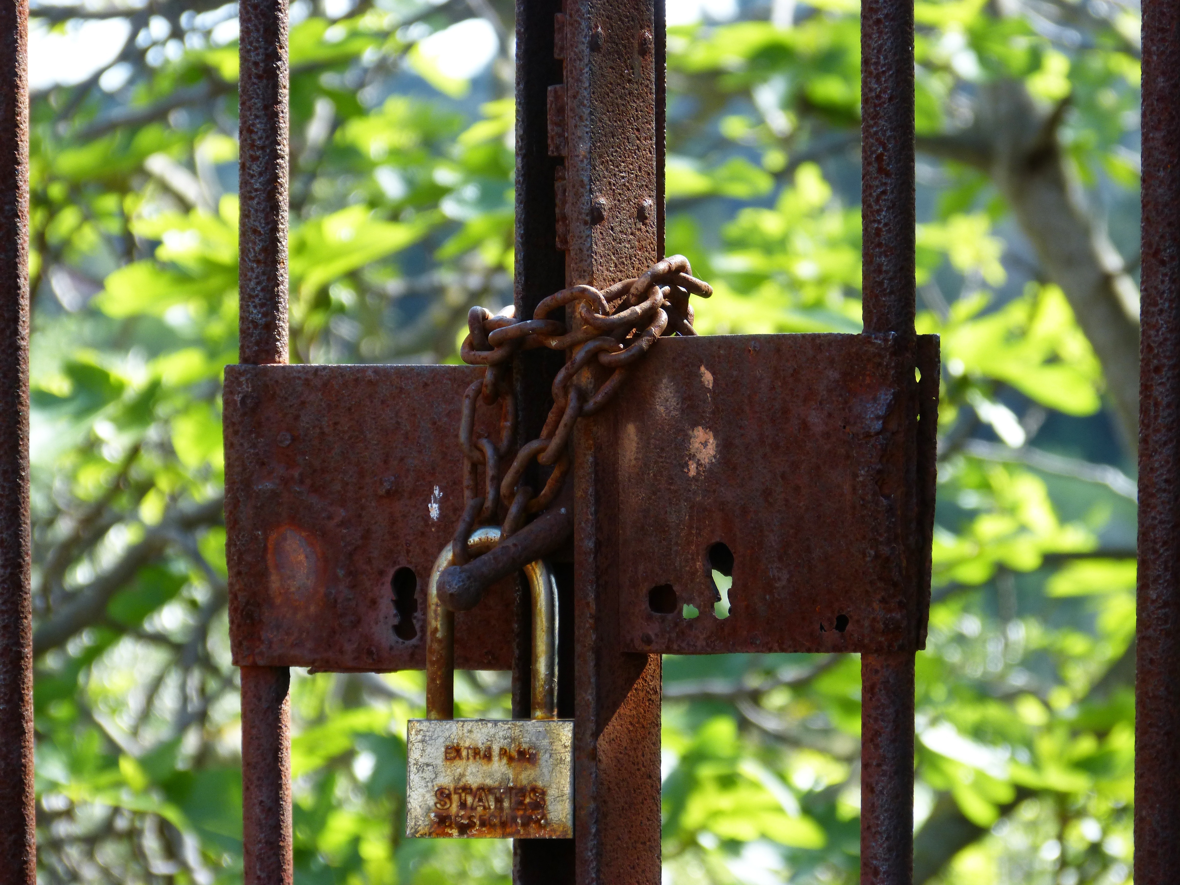 gray metal padlock with brown chain