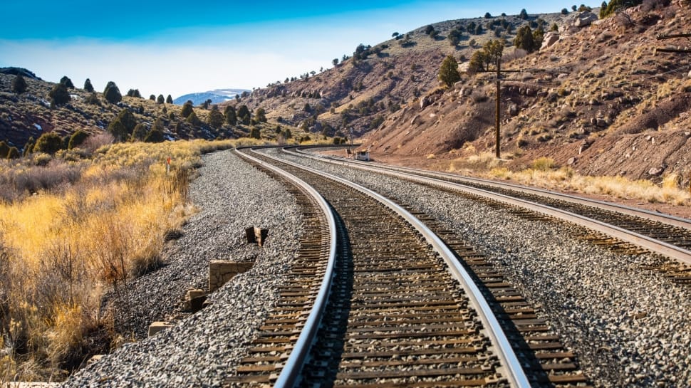grey metal railroad at daytime preview