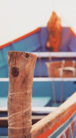 orange and blue canoe on seashore thumbnail