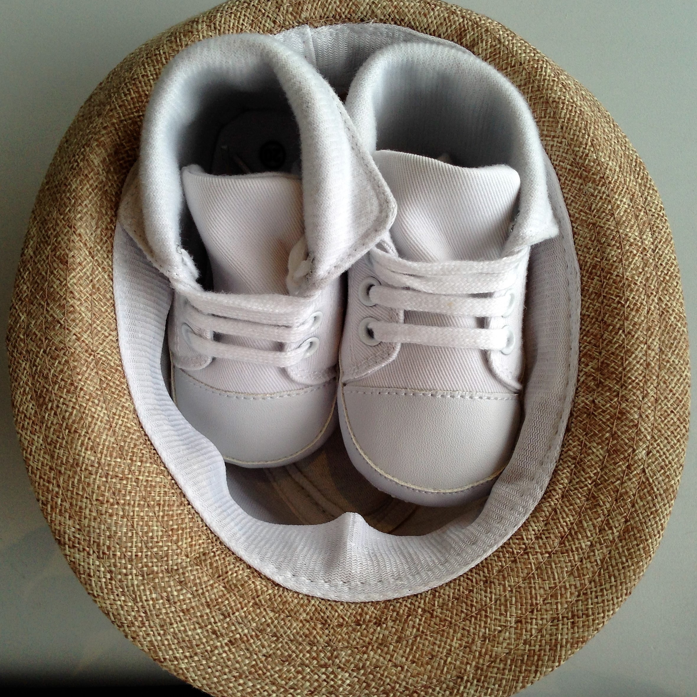children's pair of white high top shoes