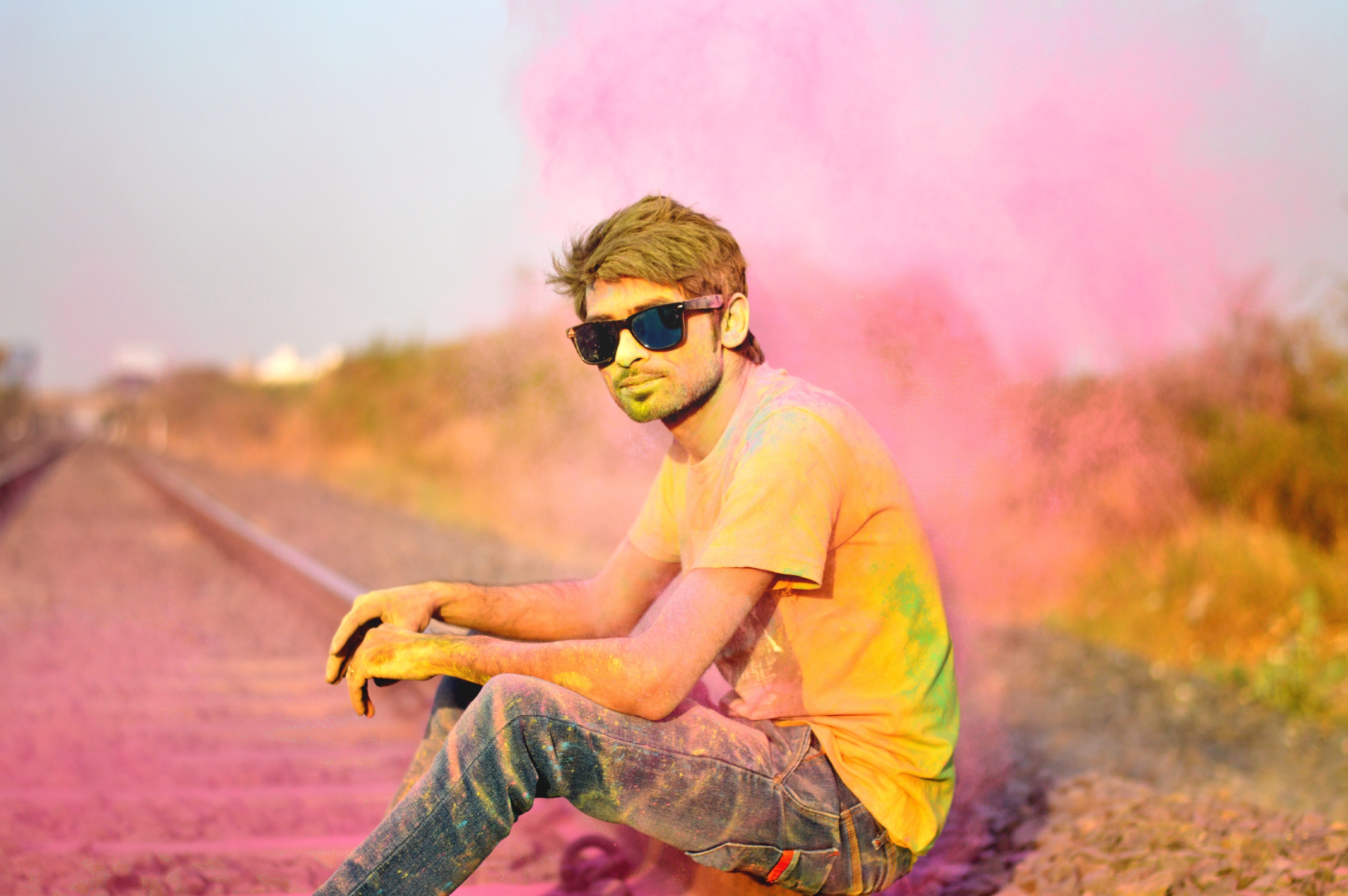 person sitting on the rail way