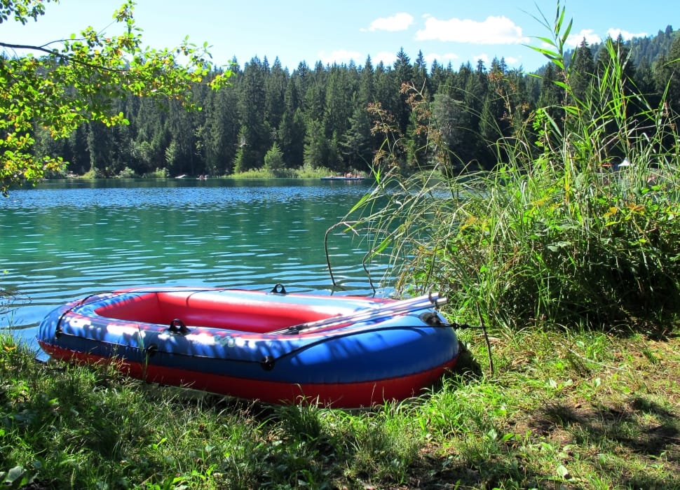 red and blue inflatable boat on green grass preview