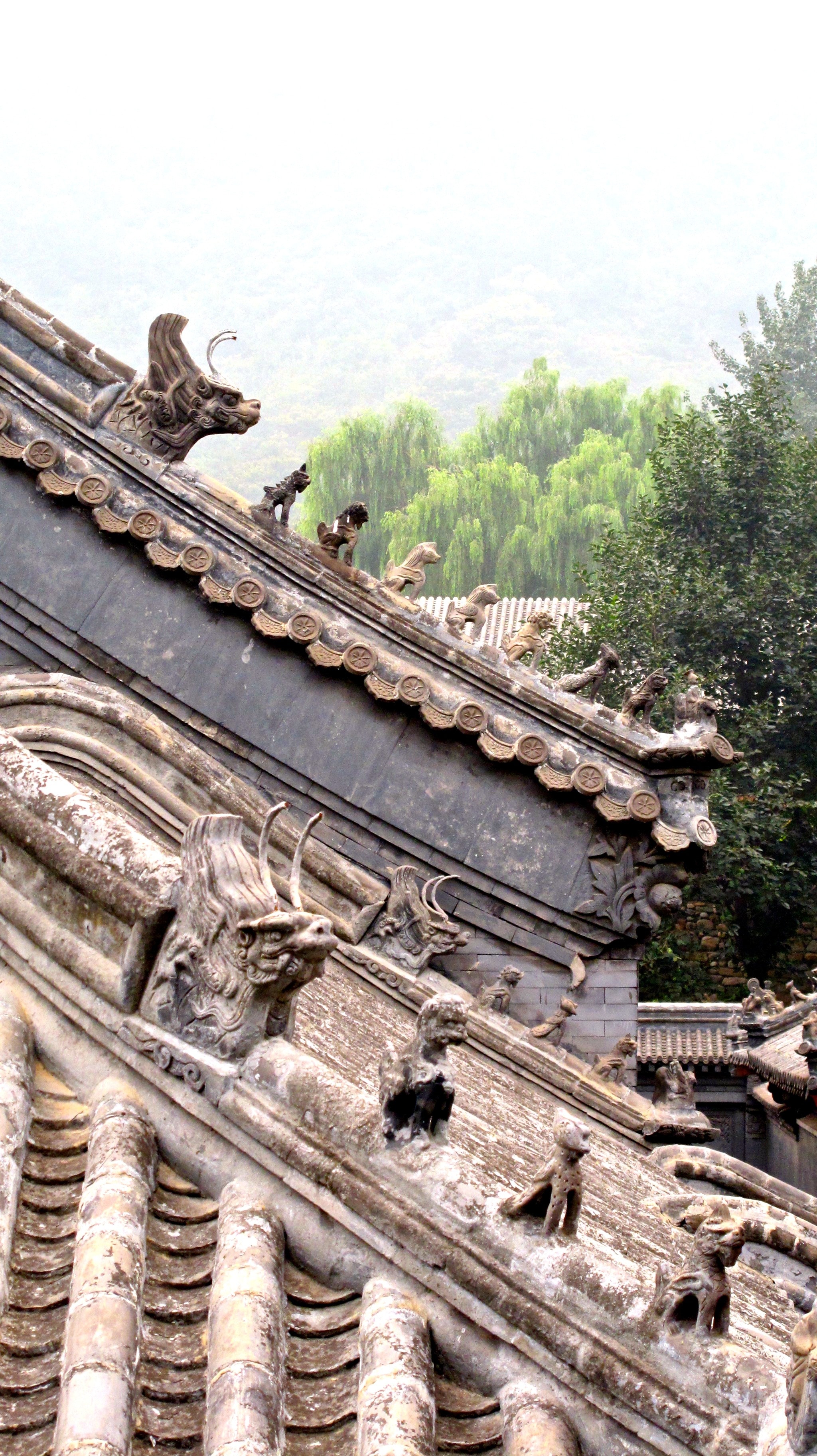 brown animal statue pagoda roof