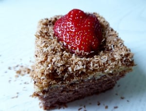 brown sliced cake with strawberry on top thumbnail
