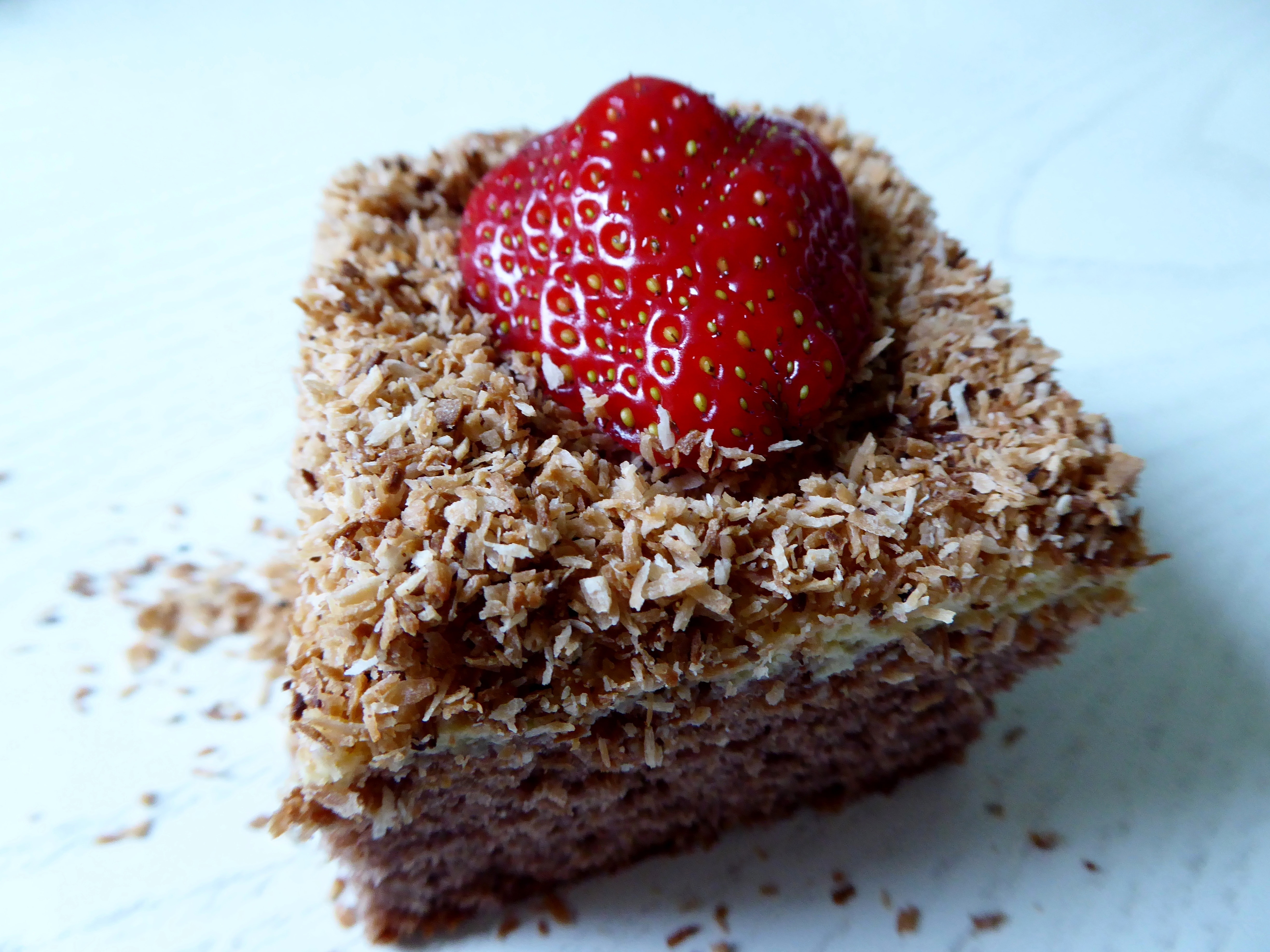 brown sliced cake with strawberry on top