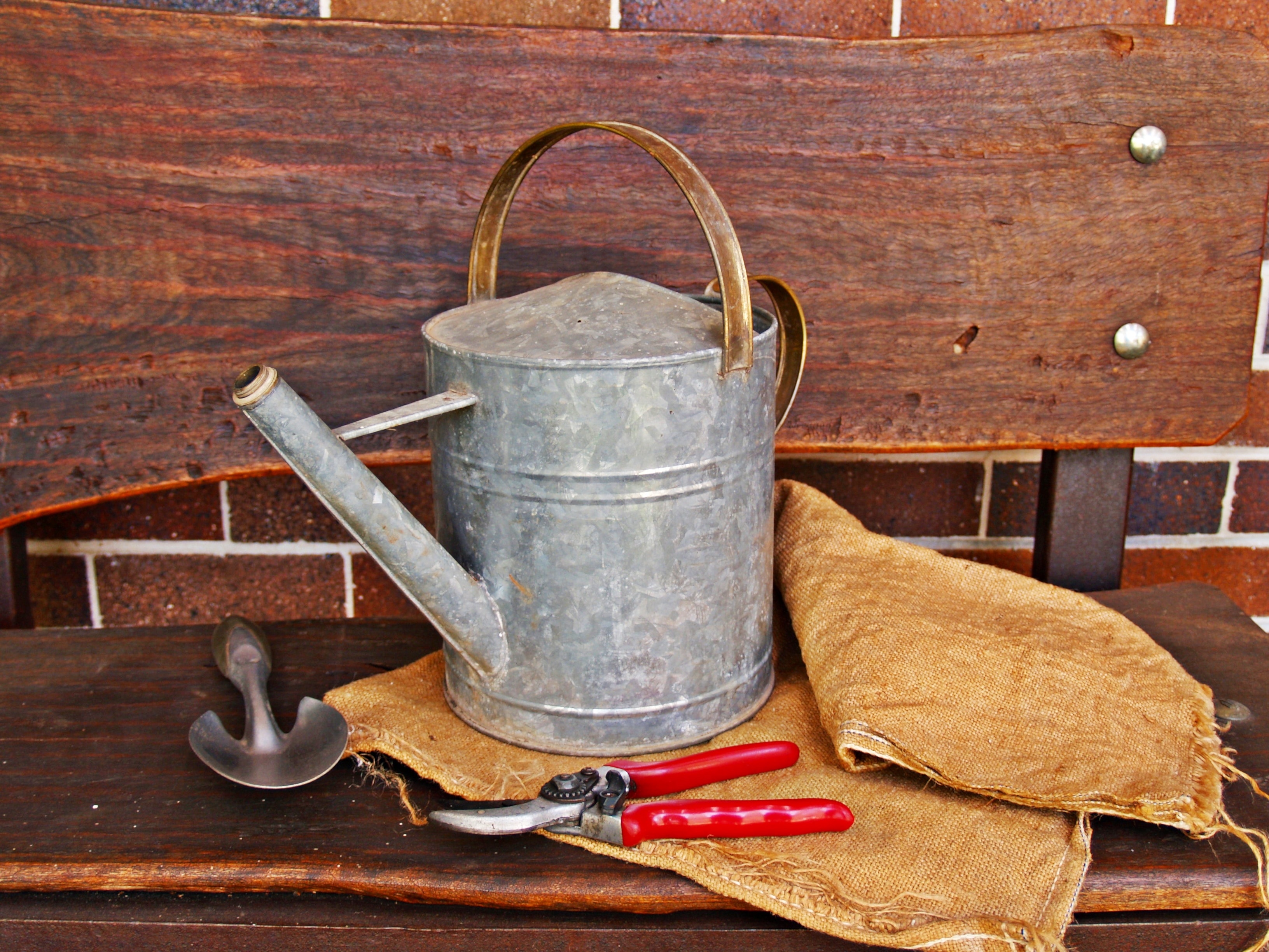 white metal watering can