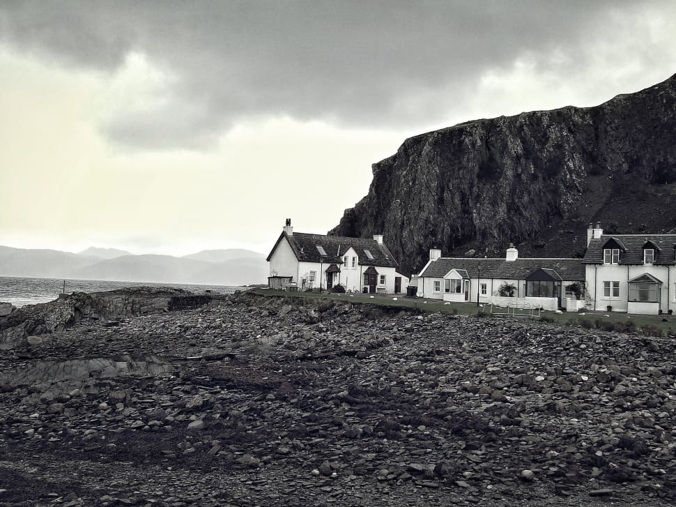 greyscale photo of house beside mountain preview