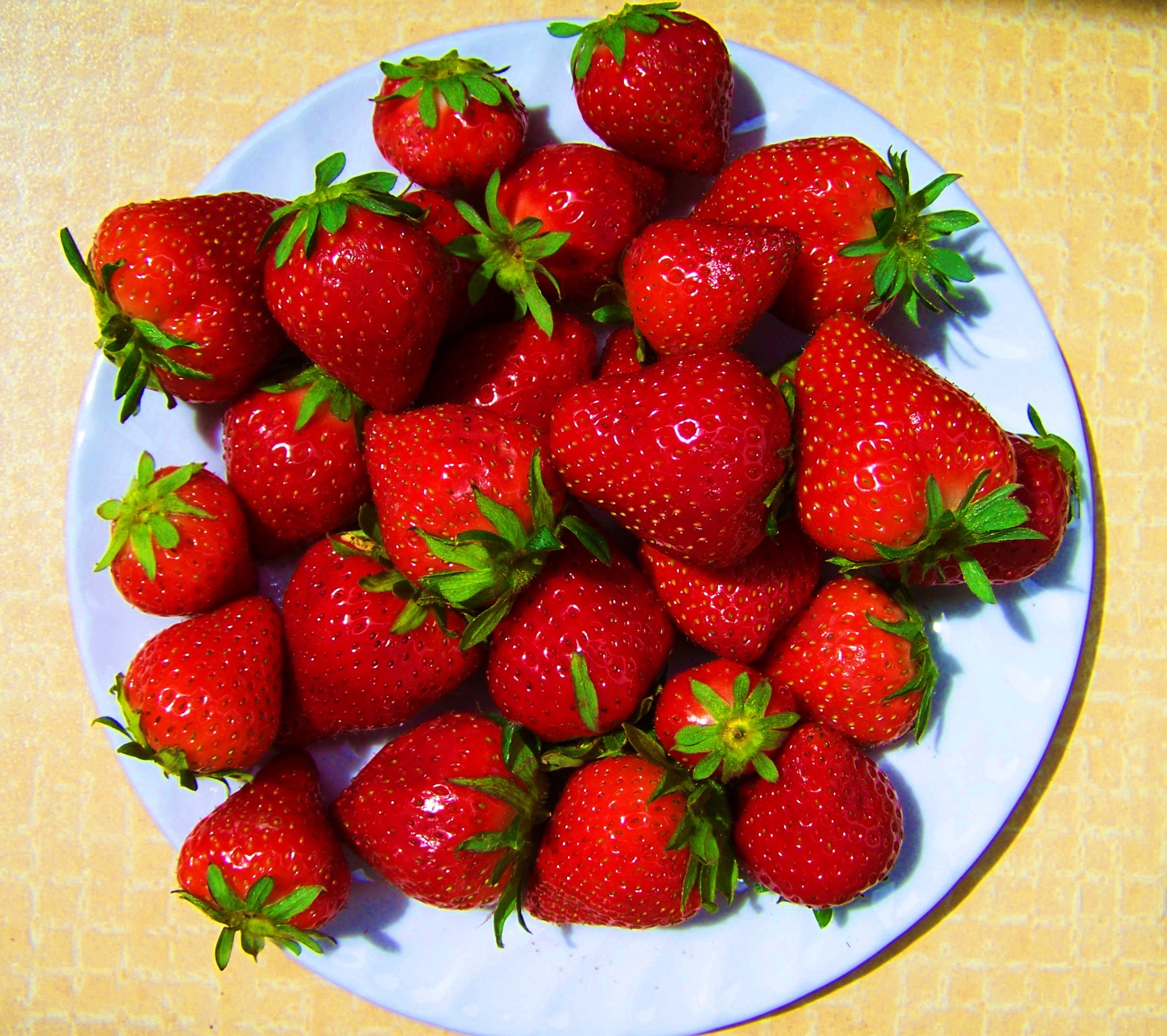 strawberries and white ceramic plate