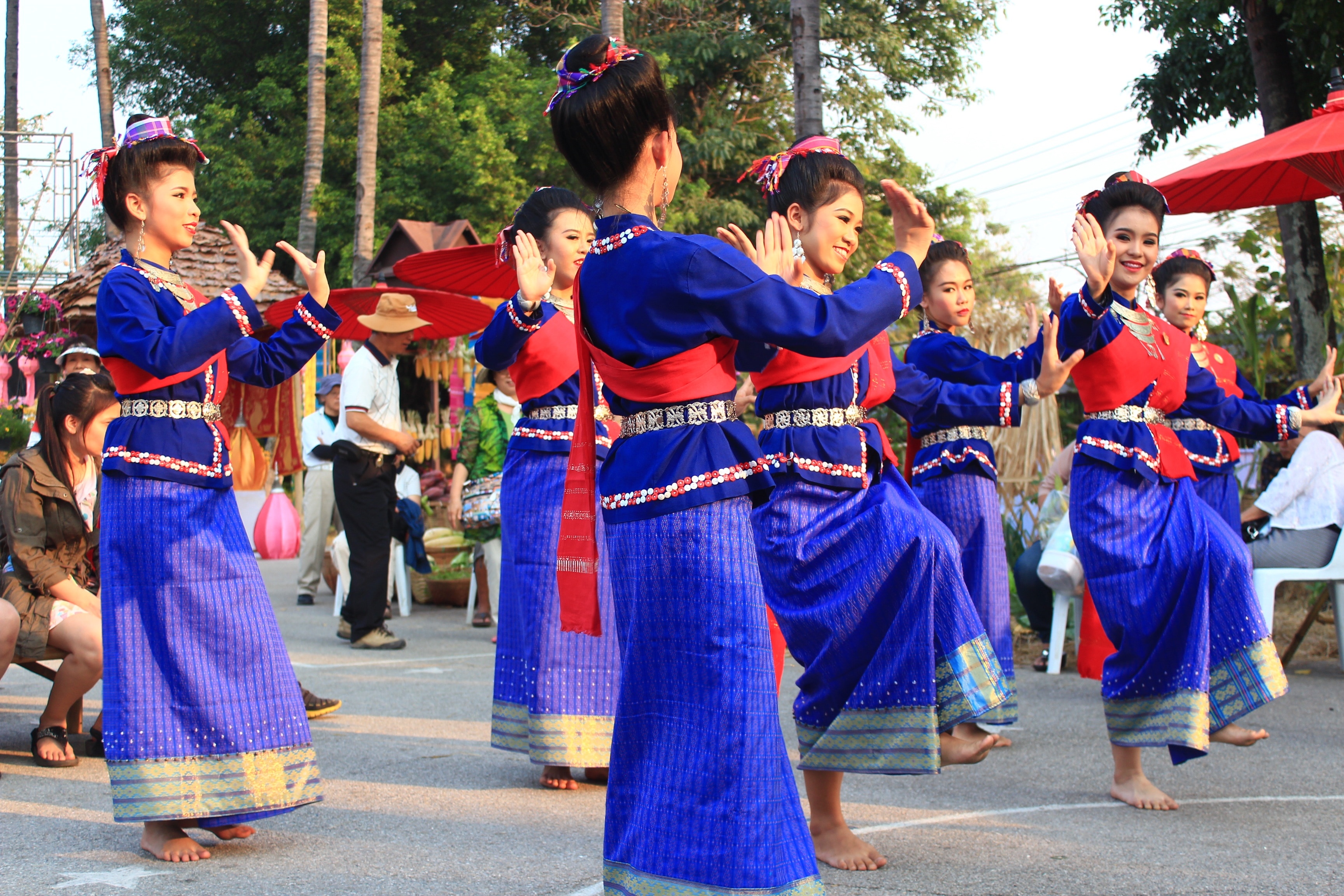 group of woman wearing blue and red long sleeve dress dancing
