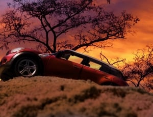 red sedan on the mountain during sunset thumbnail
