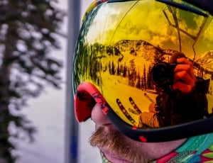 man using snow goggles during daytime thumbnail