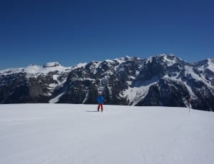 snow covered mountains with person with skis thumbnail