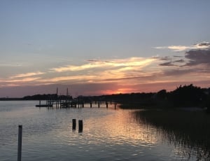 silhouette photo of dock during sunset thumbnail