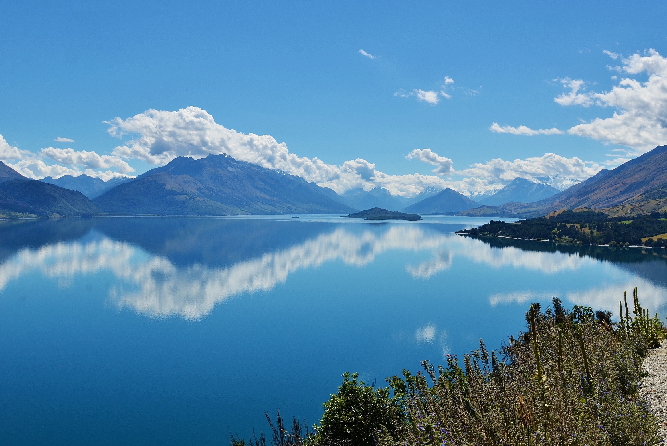 photograph of mountain besides body of water during daytime