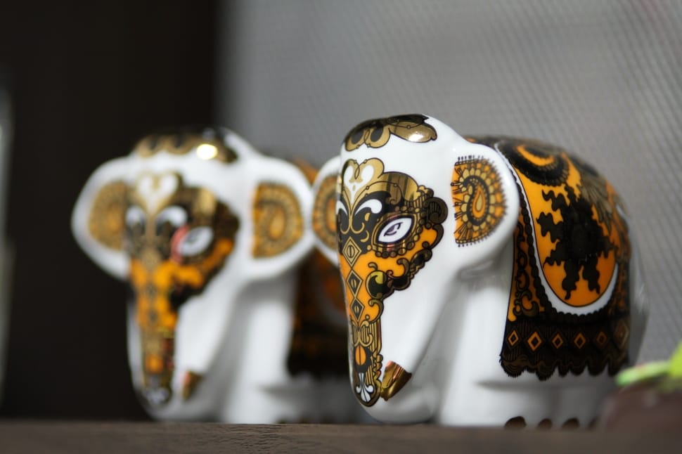 photo of two yellow-and-white ceramic elephant miniatures preview