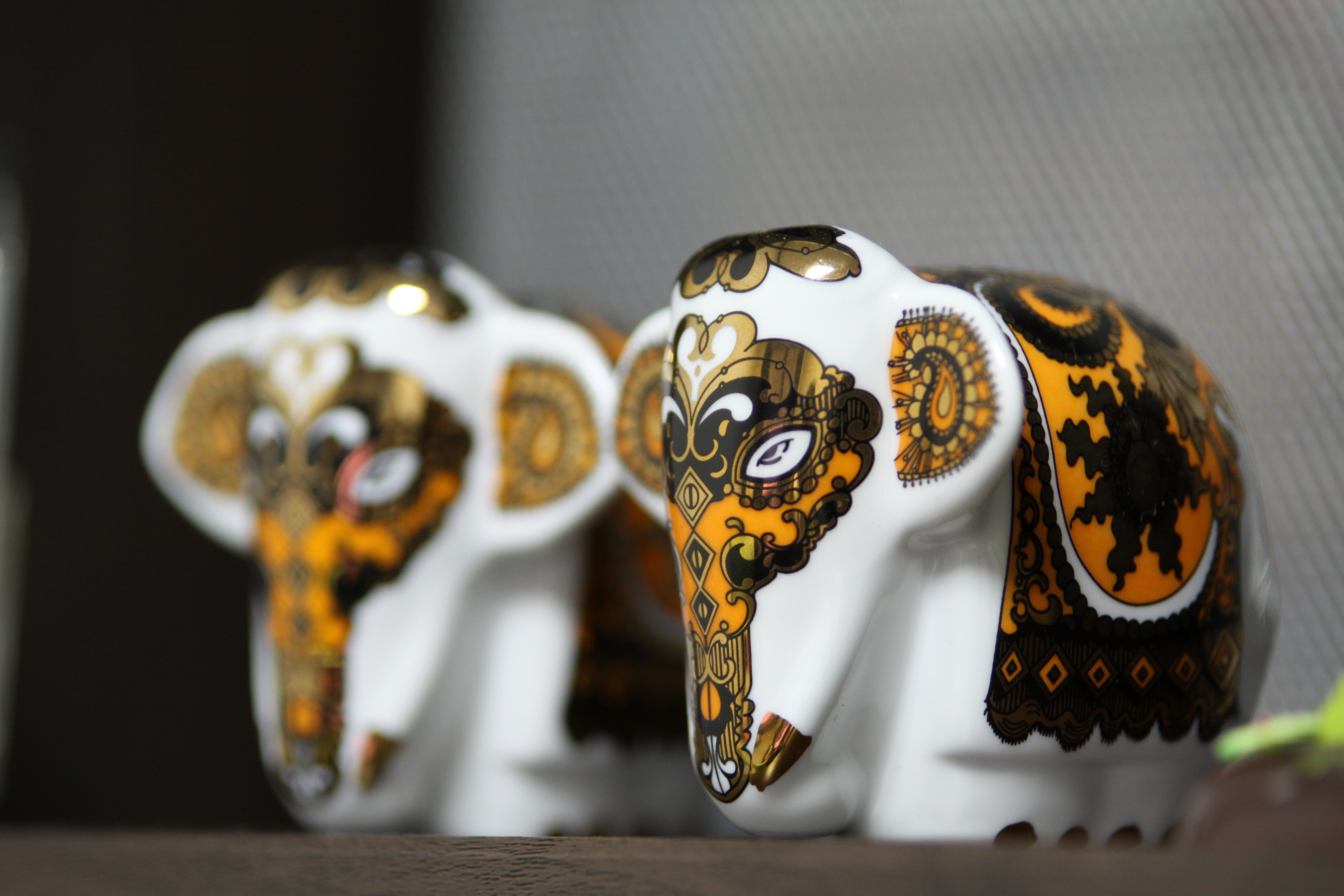 photo of two yellow-and-white ceramic elephant miniatures