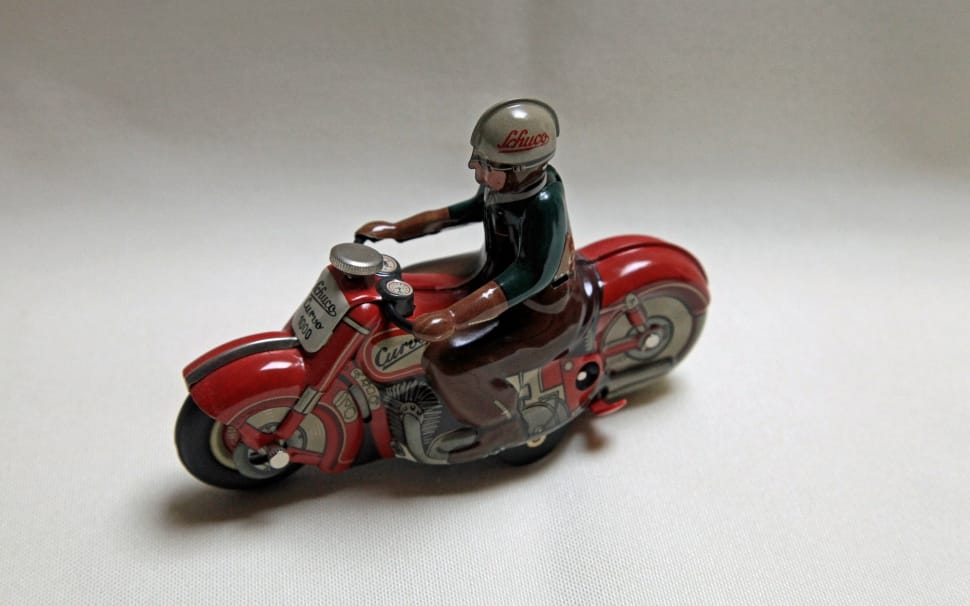 red and white man riding sports bike figurine preview