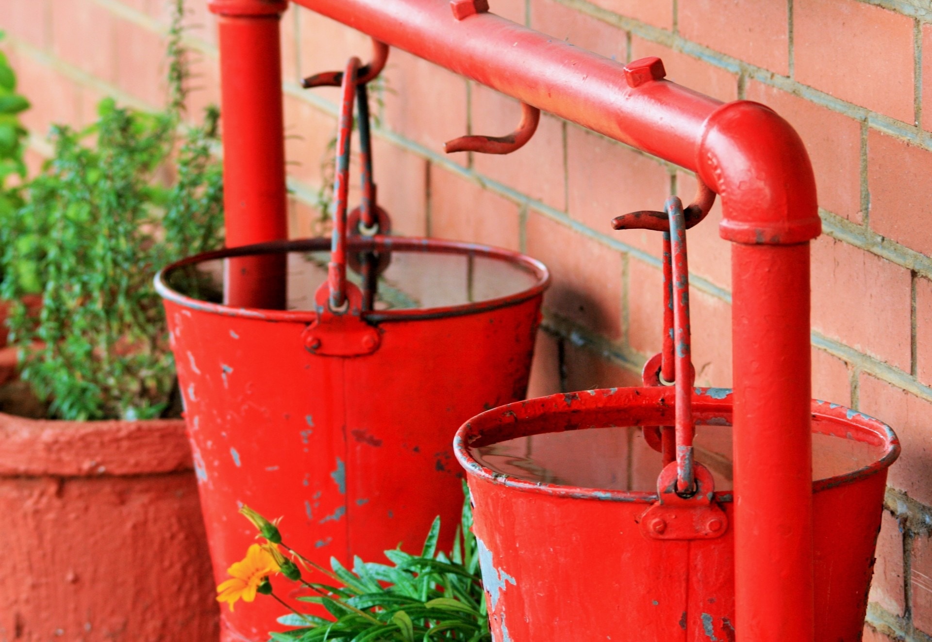 2 red metal buckets
