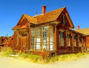 brown wooden house under blue skies during daytime thumbnail