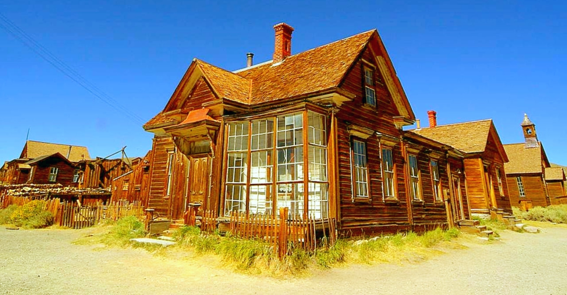 brown wooden house under blue skies during daytime
