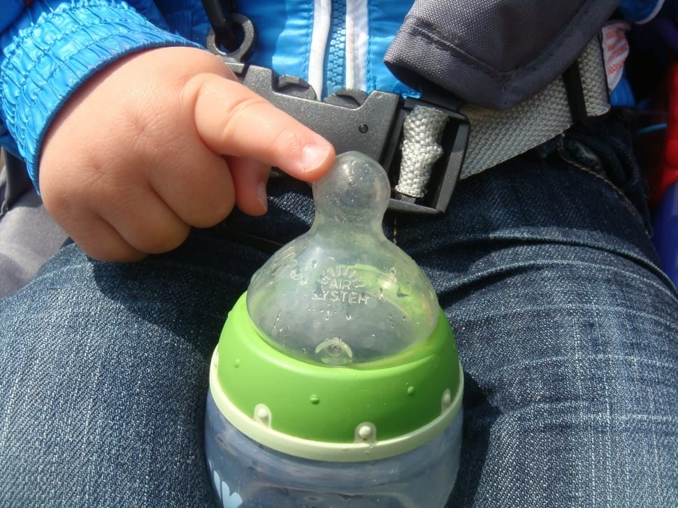 baby's white and green feeding bottle preview