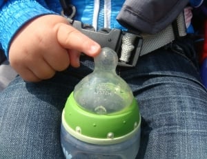 baby's white and green feeding bottle thumbnail