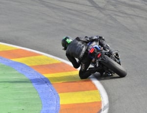 men's black leather racing jacket with black racing motorcycle thumbnail