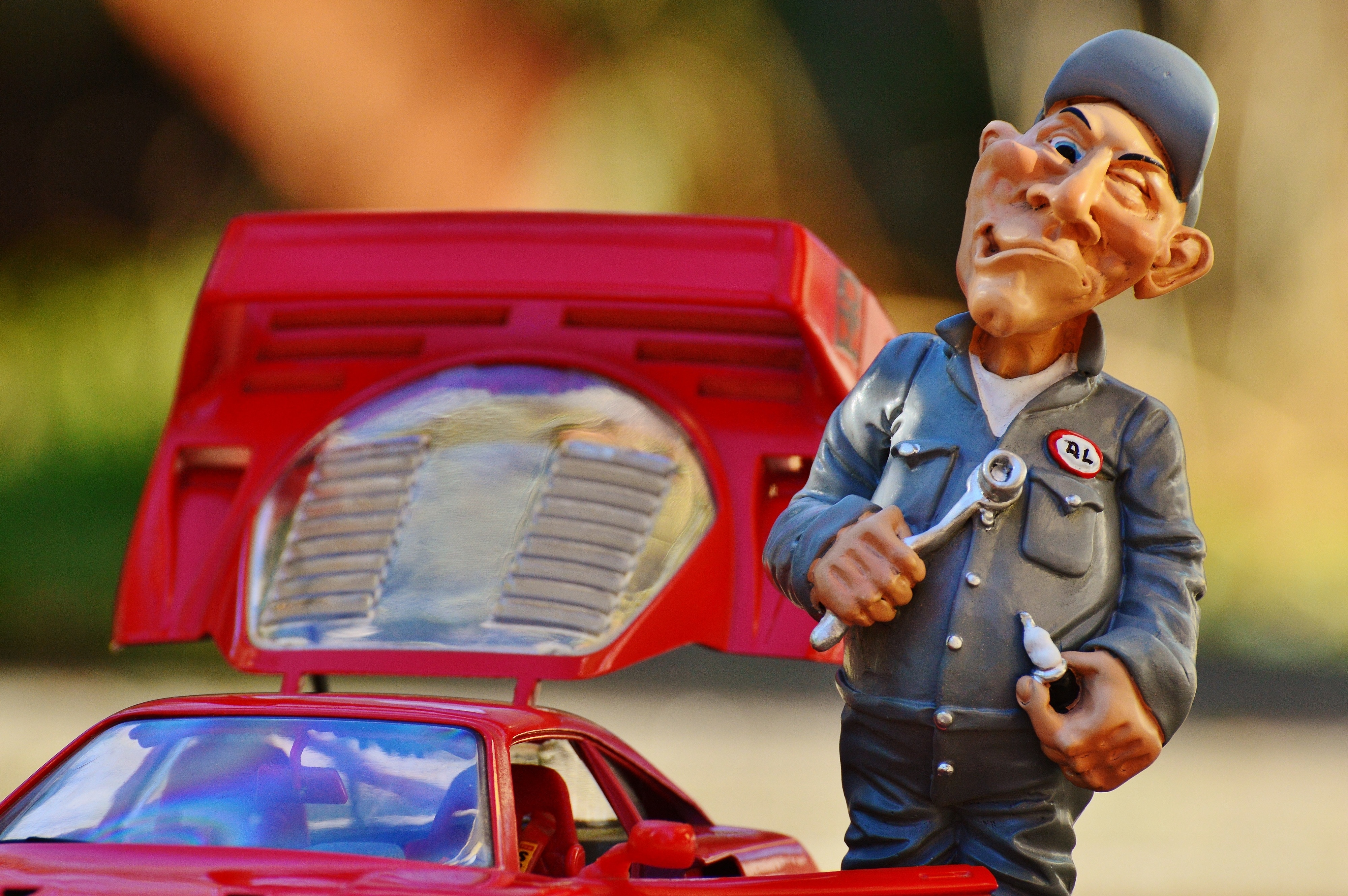 mechanic man holding tool and sports car figurine set