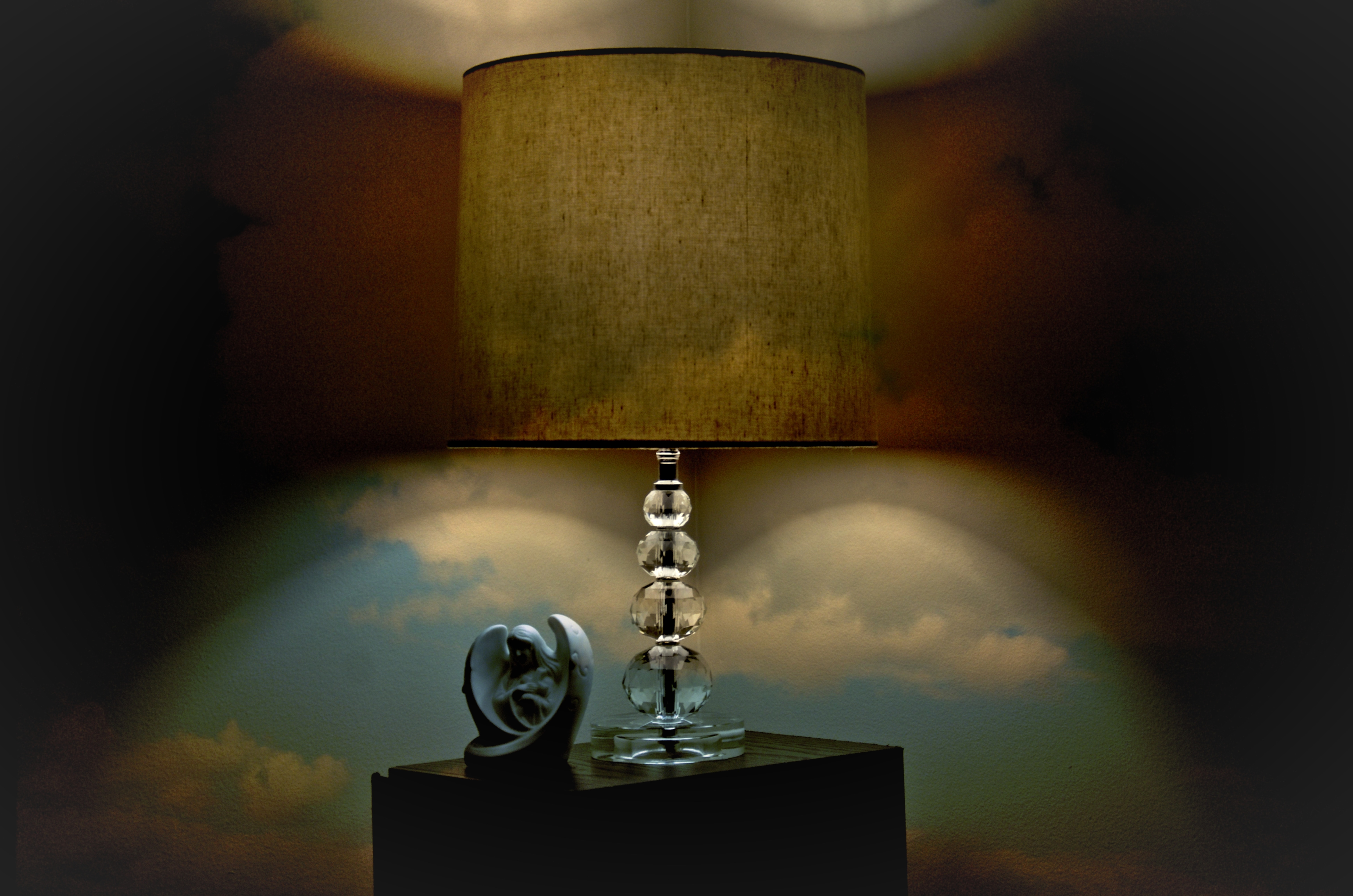 clear glass base table lamp with beige cylindrical lamp shade