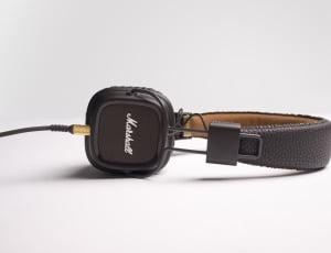 black Mashall corded headphone on white surface thumbnail
