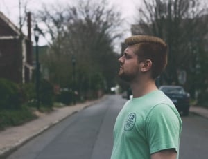man wearing green crew-neck shirt thumbnail