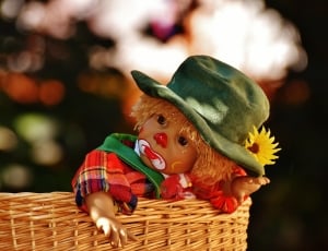 clown doll in wicker basket in close up photography thumbnail