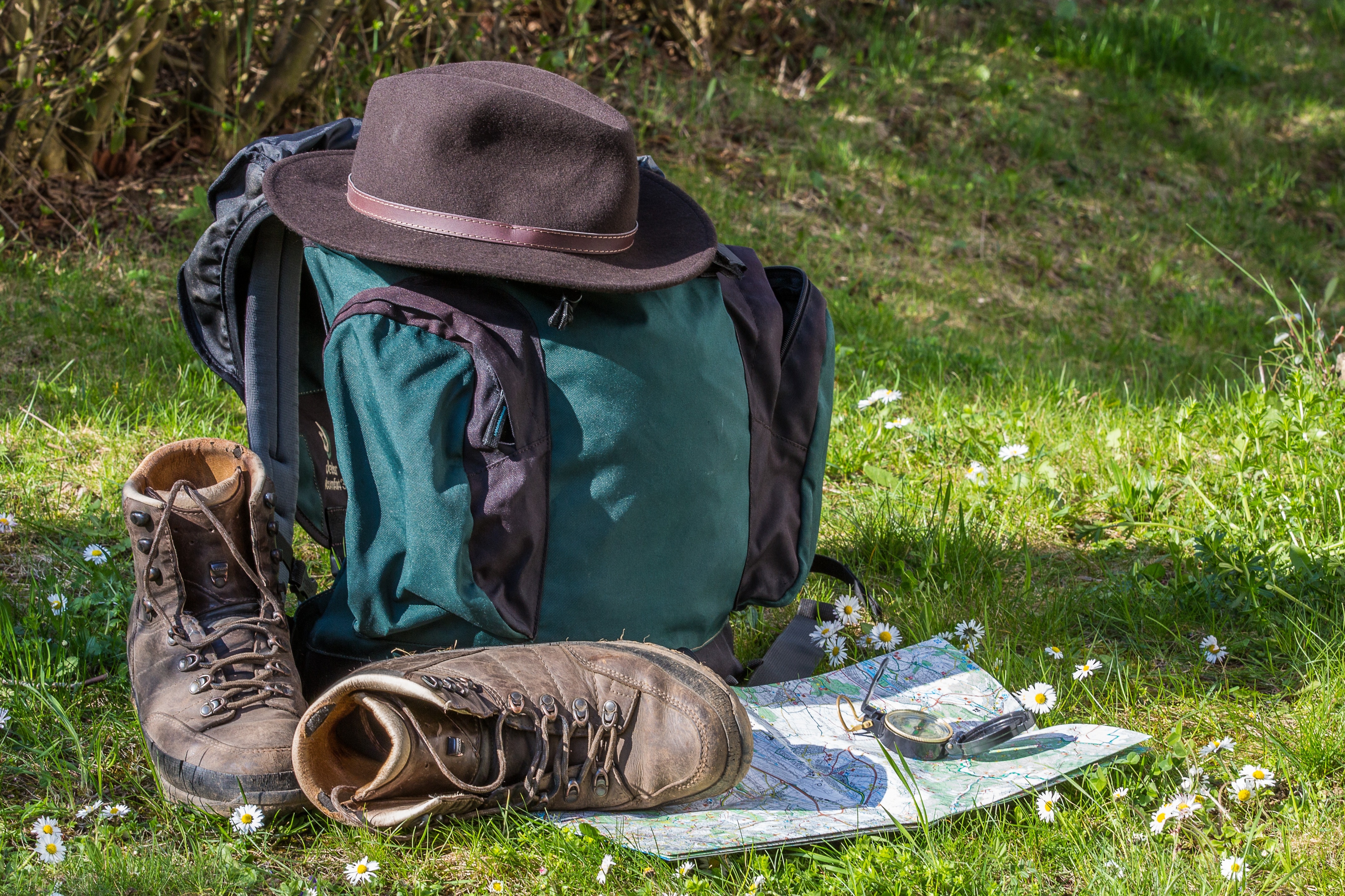 teal and blue backpack hat and brown leather hiking boots