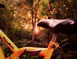 black bicycle saddle on yellow mountain bike thumbnail