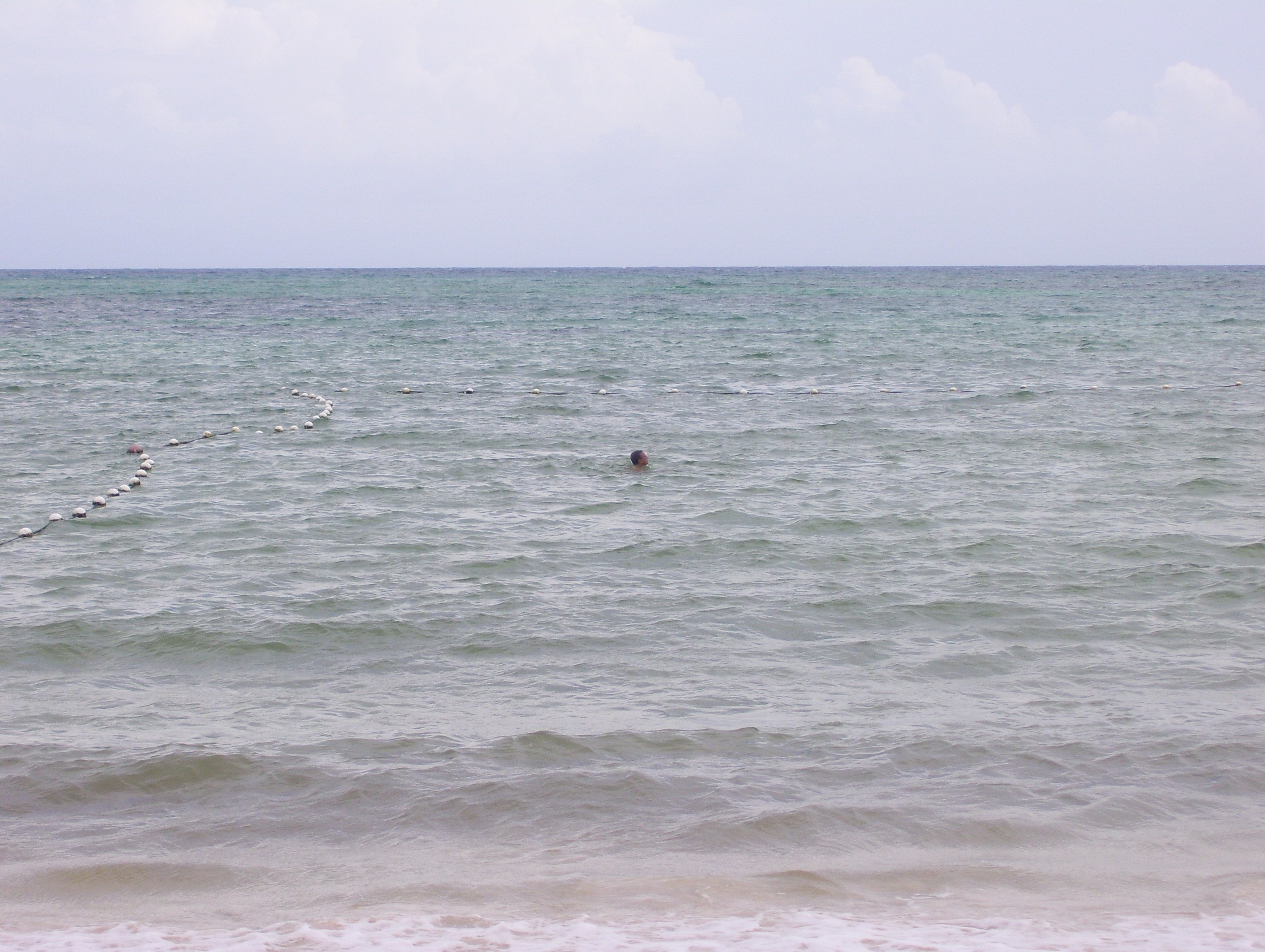 person swimming in the sea during daytime