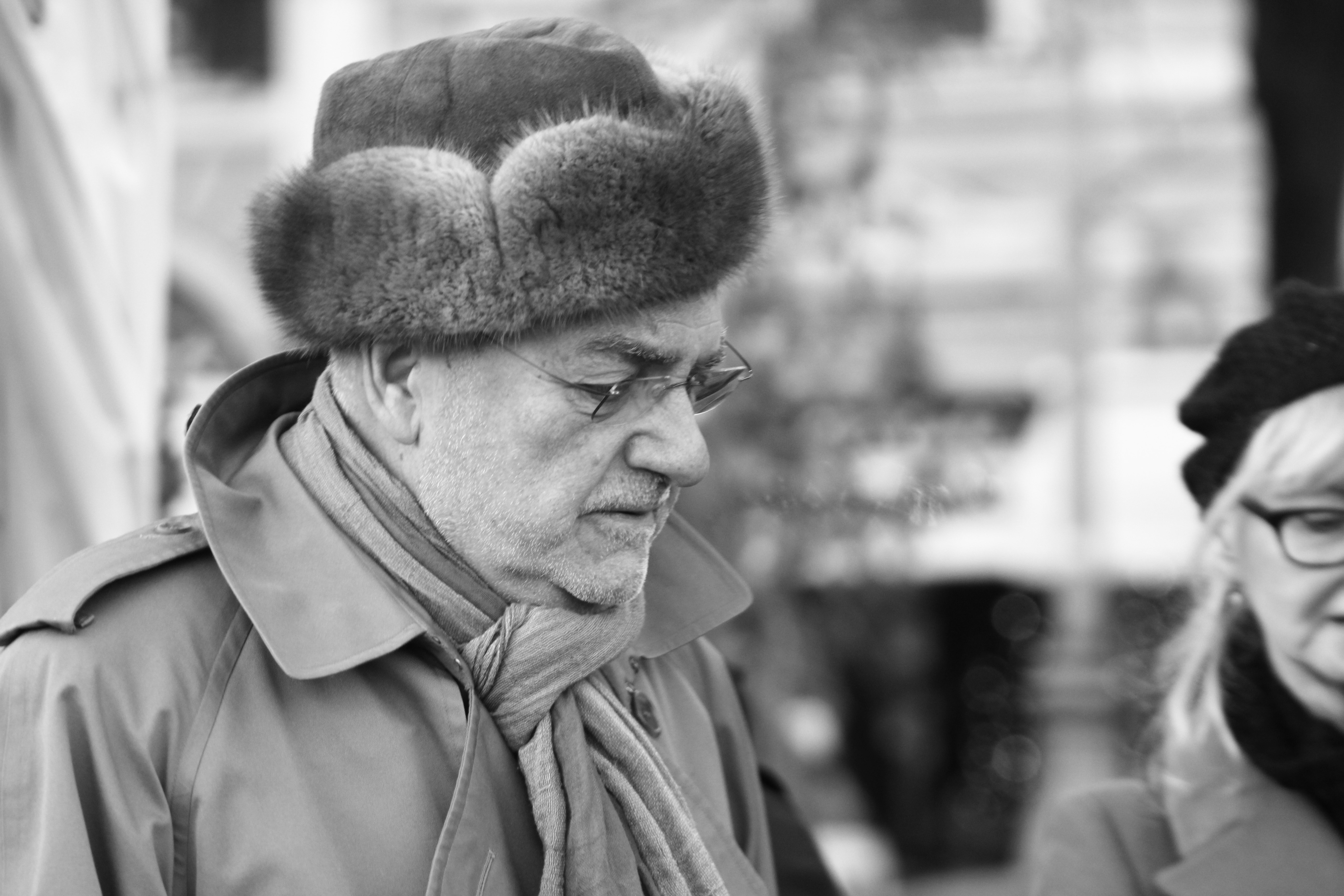 grayscale photo of man with winter hat and coat