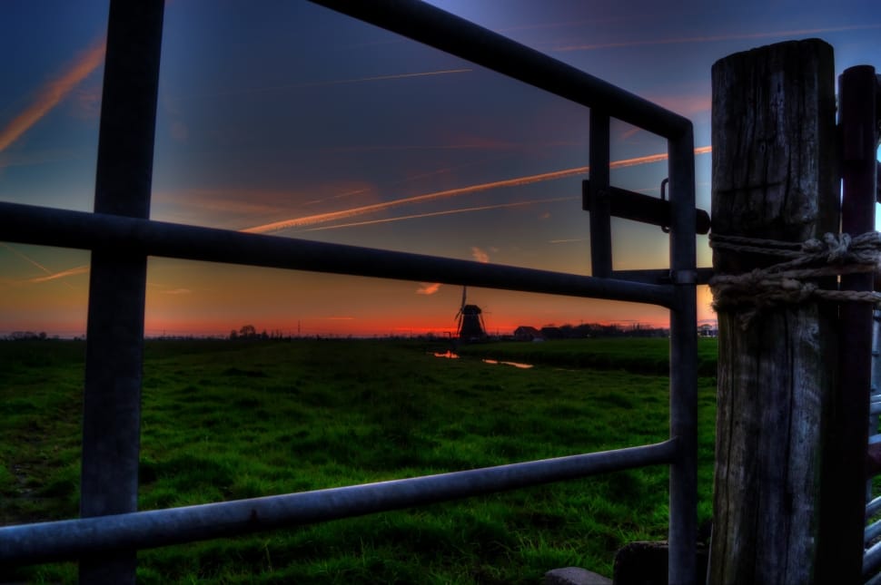 windmill in green grass field during nighttime preview