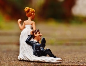 figurine of bride dragging her groom thumbnail