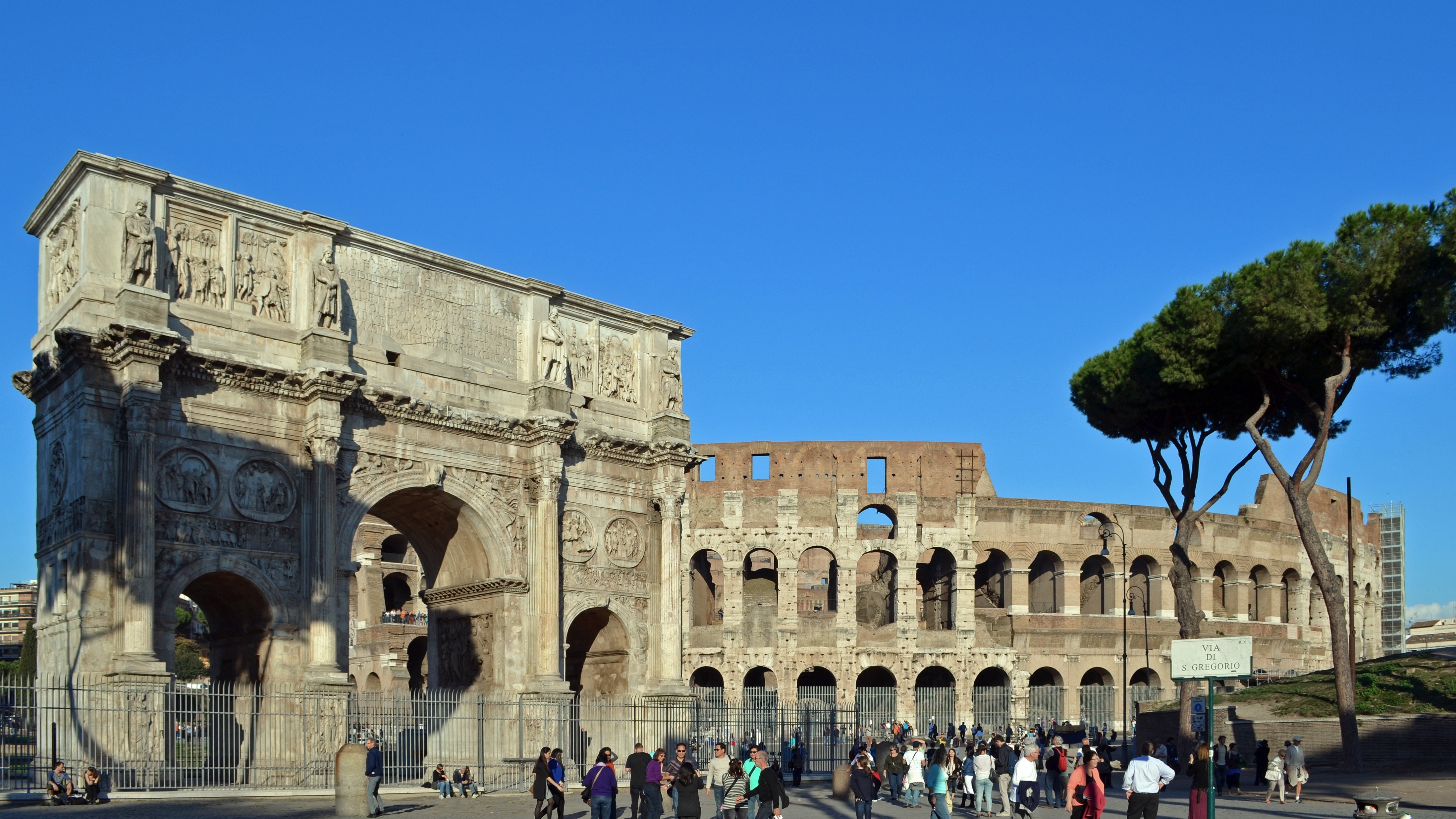people standing outside The Colosseum during daytime