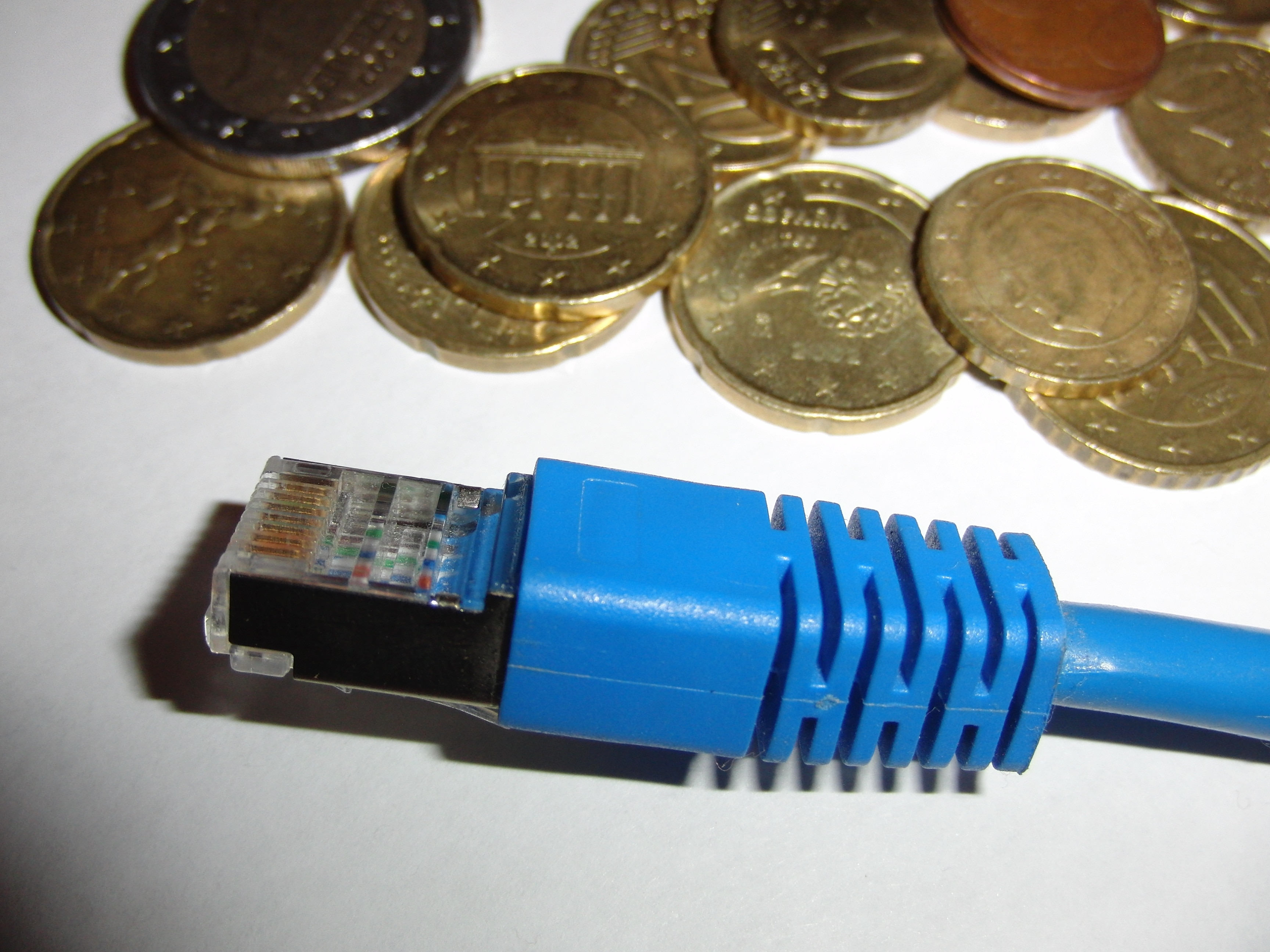 blue ethernet cable near coins